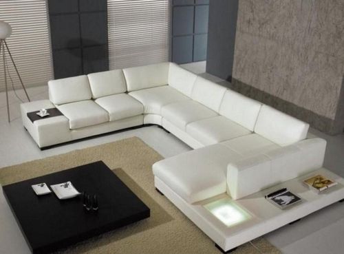 Диваны в зал: фото в квартире, кресла и большая мебель, как поставить кровать, красивый интерьер, выбор пуфика